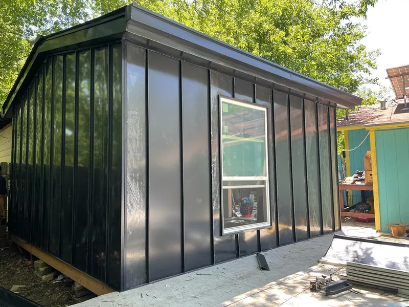 Black standing seam metal wall panels for Metal Roof Installation in Comstock